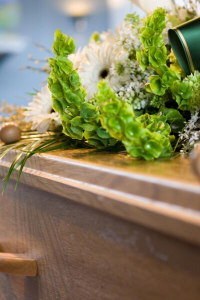 A coffin with a flower arrangement at a mortuary