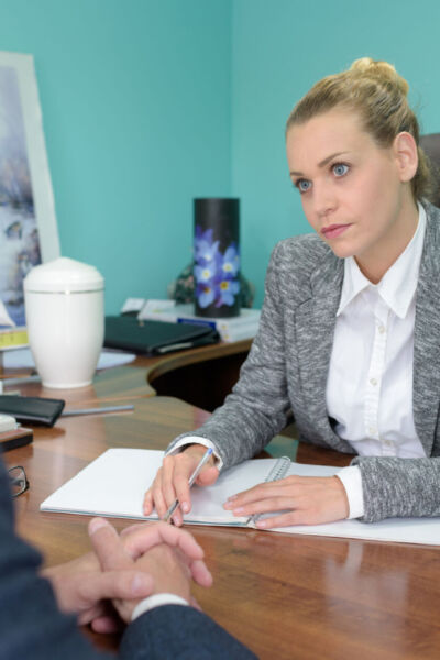 female funeral director in meeting with senior man